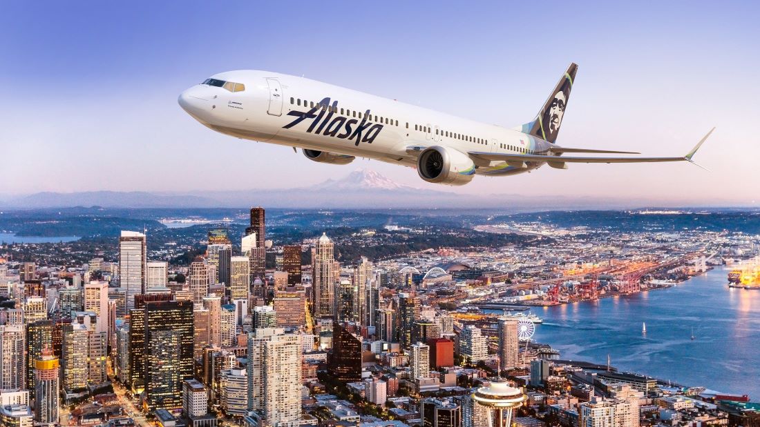 Alaska Airlines plane flying over city