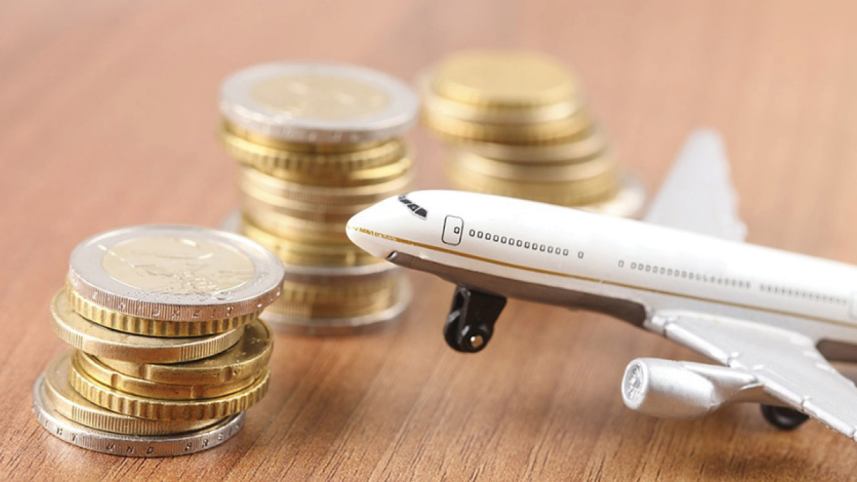 Toy airplane on table with gold coins