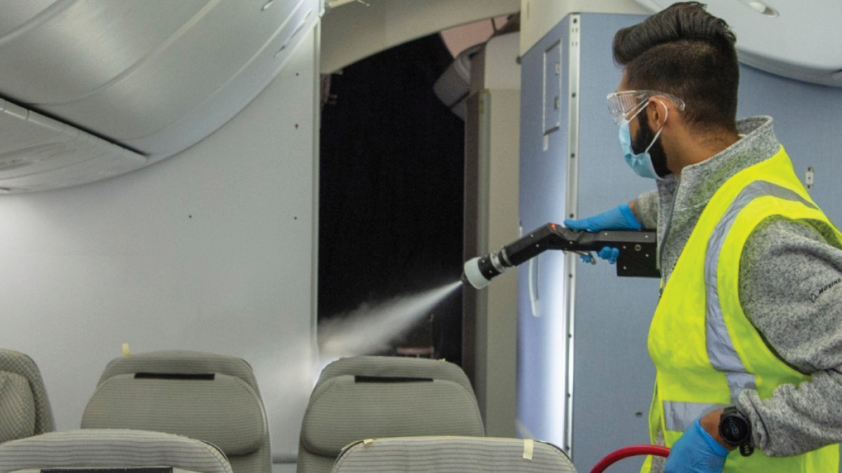 Man disinfecting plane