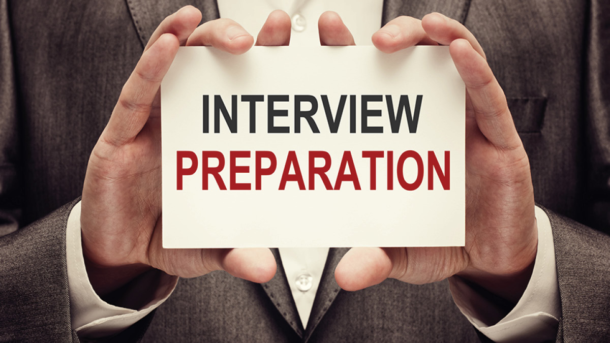 Man holding up sign that reads Interview Preparation