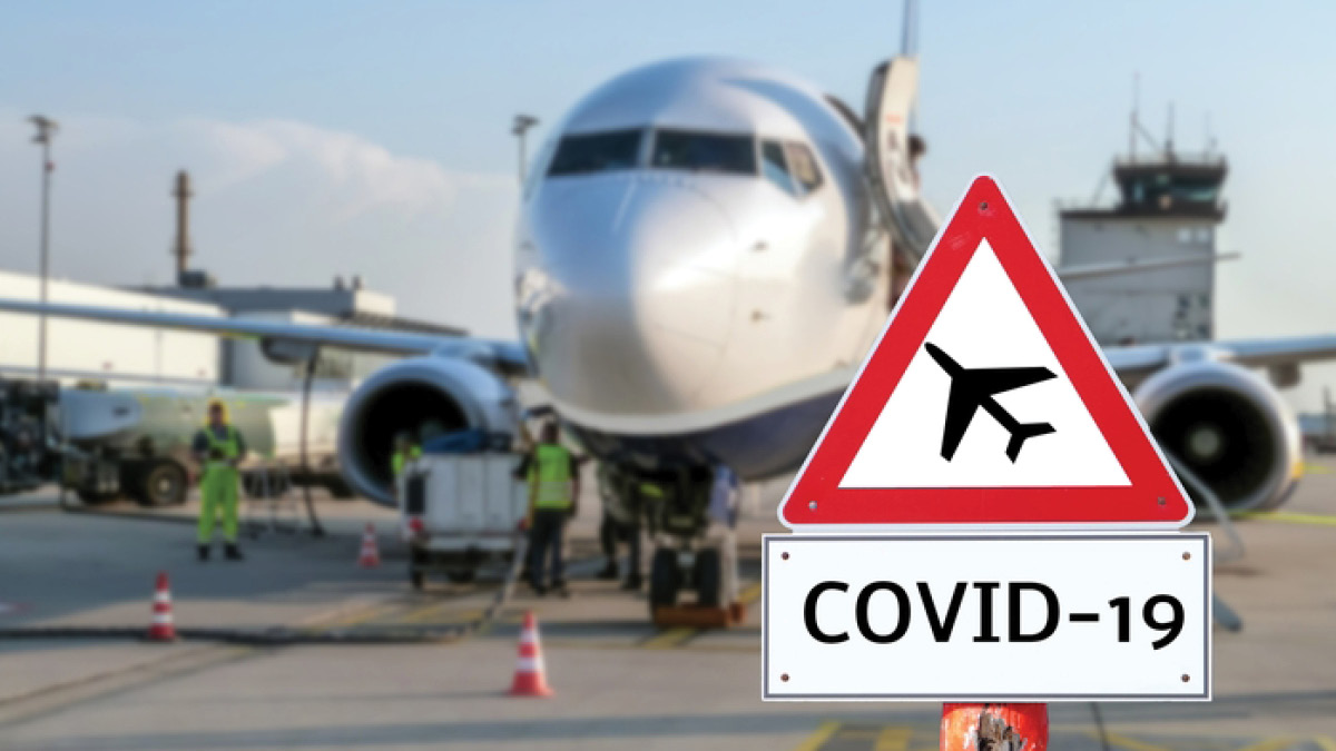 Plane on runway with COVID on aircraft warning sign