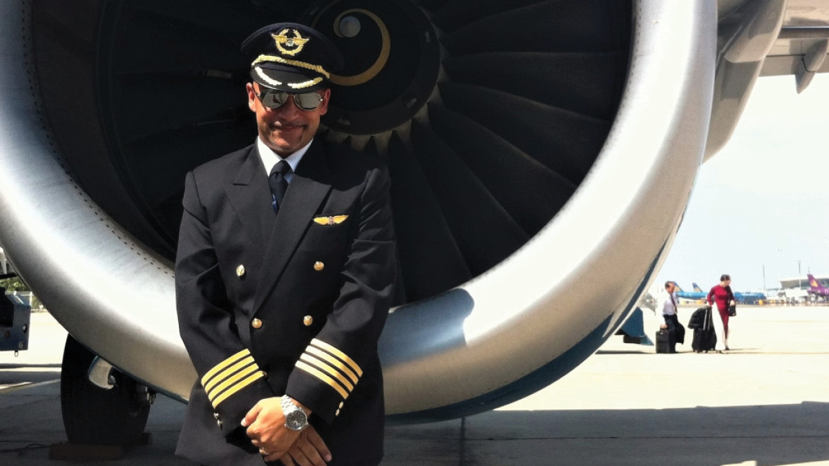 Pilot Francesco Patella in front of airplane engine