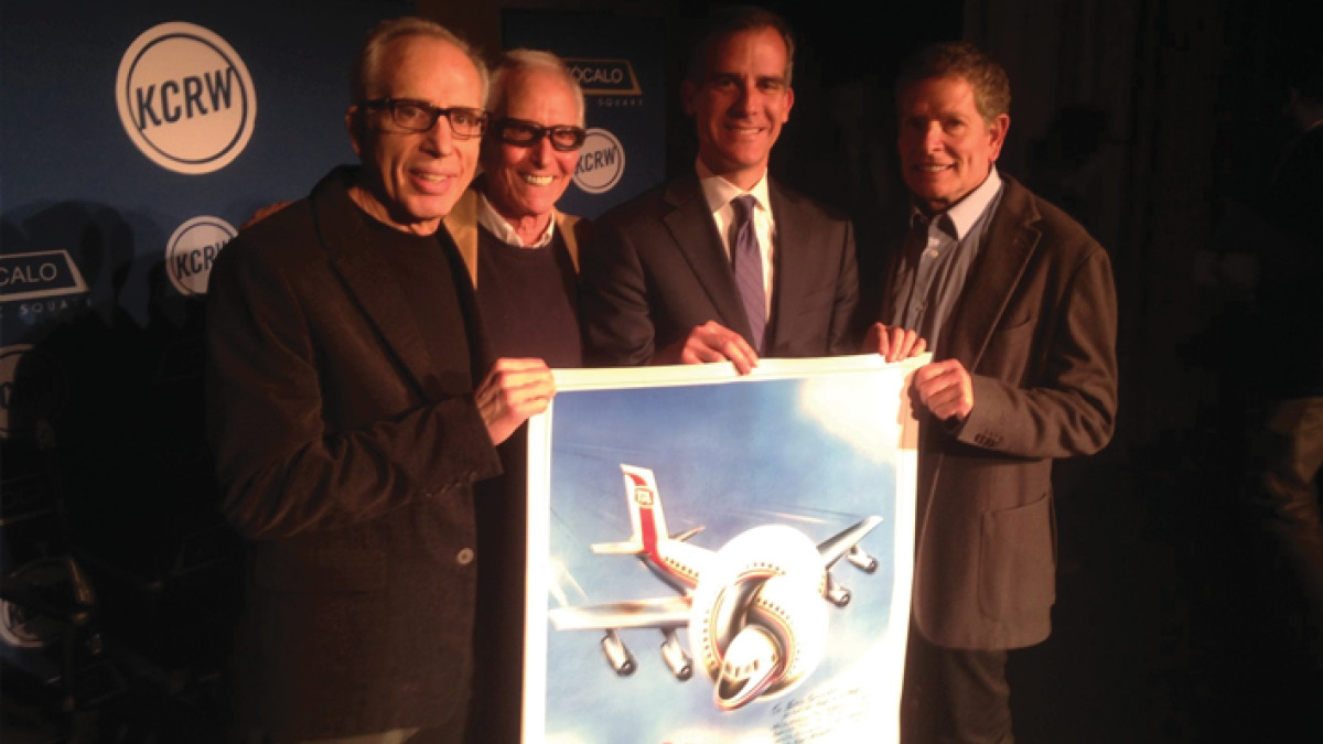 The cast of the movie Airplane! holding up movie poster