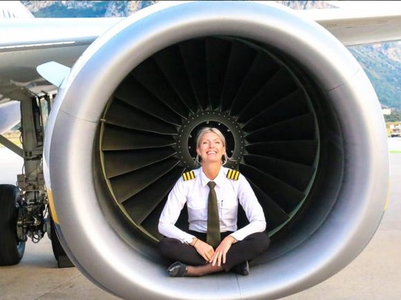 Pilot Maria sitting in airplane engine