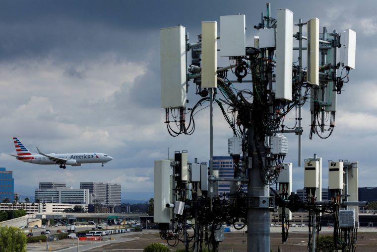cell phone tower with plane
