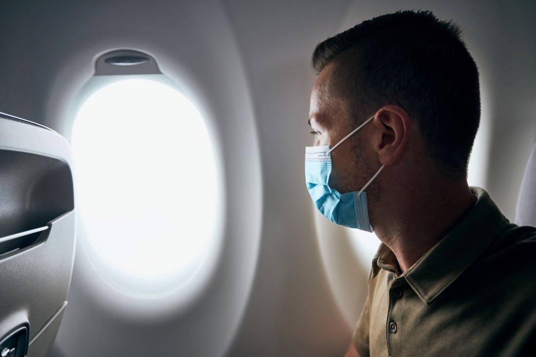 passenger on plane with mask