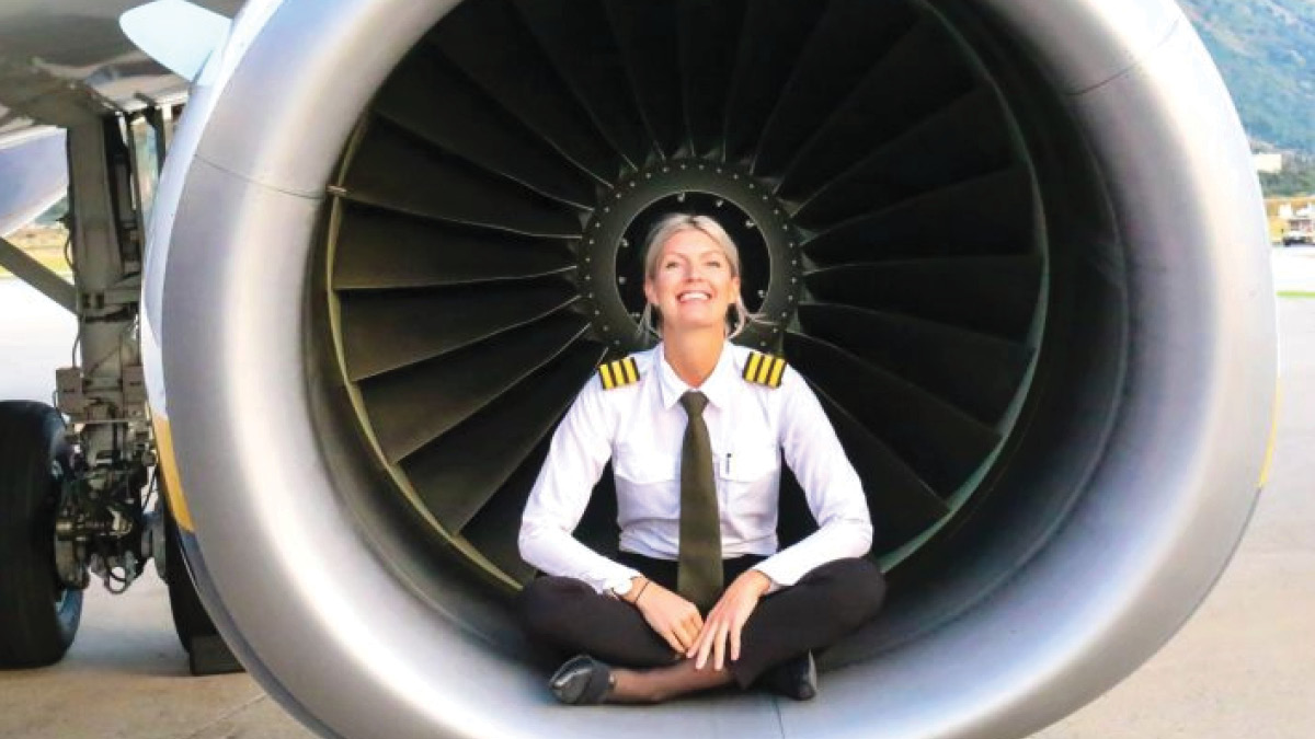 Pilot Maria sitting in airplane engine